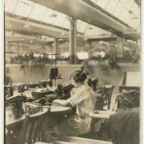 Joseph & Feiss Co. employee Nellie Santo Lanese working at sewing machine