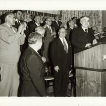 Abba Hillel Silver standing at podium, surrounded by group, during Zionist Organization of Americaa event, circa 1950s